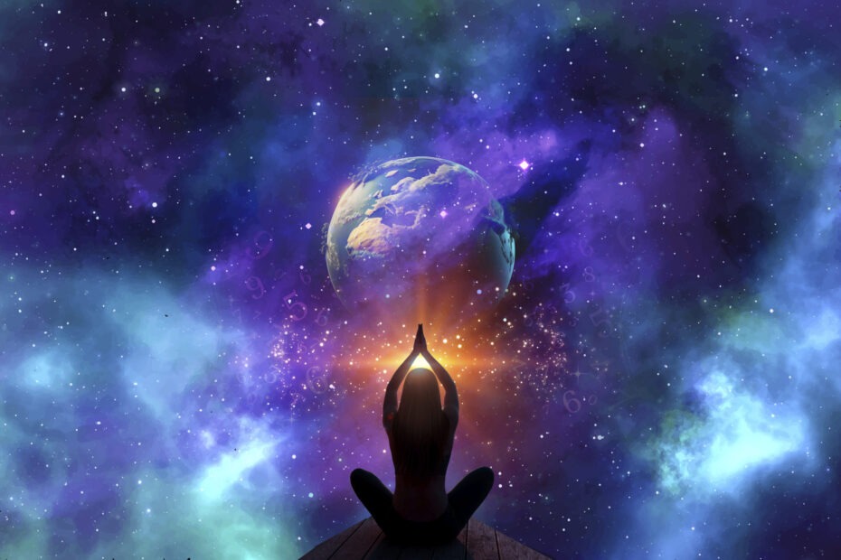 a person sitting on a wood surface with hands together in front of the earth